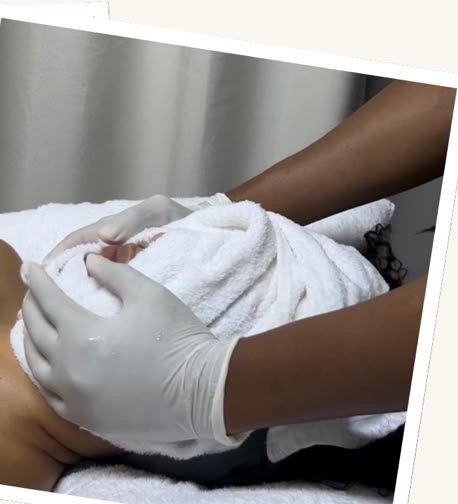 Therapist performing a warm back steam and scrub treatment at Nirvana Nook